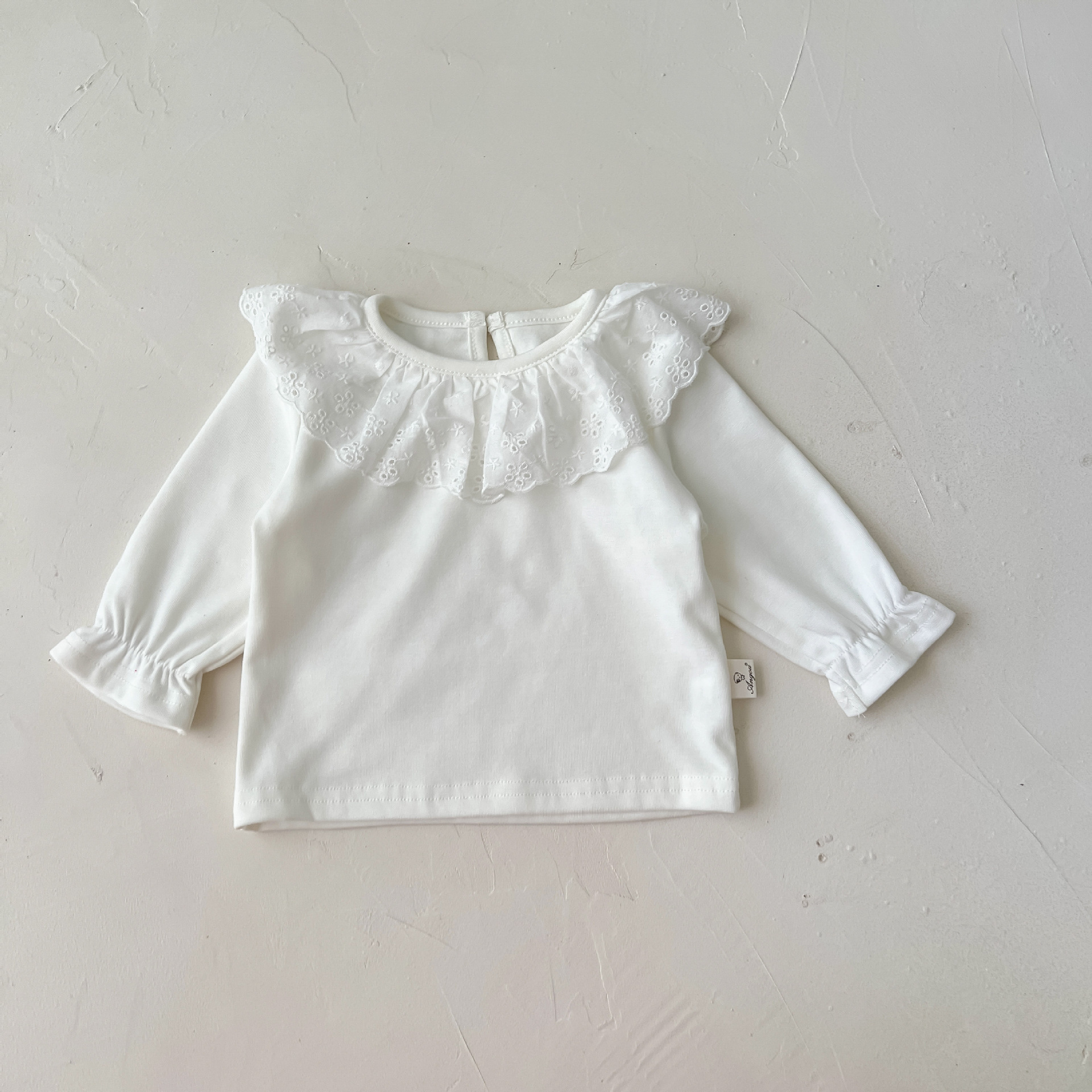 Adorable baby suspender romper with lace detail and soft inner shirt